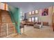 Spacious living room showcasing brick staircase, tile flooring, and cozy seating area at 5785 N Tee Pee Ln, Las Vegas, NV 89149