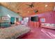 Large main bedroom with unique wood ceiling, red concrete floors, and views to the outside at 5785 N Tee Pee Ln, Las Vegas, NV 89149