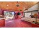Expansive main bedroom with wood-beamed ceilings, natural light, and outside access at 5785 N Tee Pee Ln, Las Vegas, NV 89149