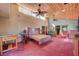 Expansive main bedroom with unique wood ceiling, red concrete floors, and sliding glass doors to balcony at 5785 N Tee Pee Ln, Las Vegas, NV 89149