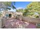 Lovely rooftop patio with seating, mature trees, and desert landscaping, accessible through sliding glass doors at 5785 N Tee Pee Ln, Las Vegas, NV 89149