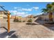 Expansive backyard with desert landscaping, shade structure, and mountain views at 6345 Strongbow Dr, Las Vegas, NV 89156
