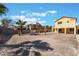Large backyard with shade structure, palms, and privacy wall at 6345 Strongbow Dr, Las Vegas, NV 89156