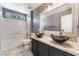 Bathroom with dual vessel sinks, a large mirror, and a tub-shower combination at 6345 Strongbow Dr, Las Vegas, NV 89156