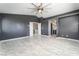 Spacious primary bedroom features a ceiling fan, ensuite bathroom, and walk-in closet at 6345 Strongbow Dr, Las Vegas, NV 89156
