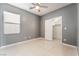 Bedroom features tile floor, ceiling fan, closet and a bright window at 6345 Strongbow Dr, Las Vegas, NV 89156