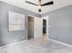 Bedroom with gray walls, ceiling fan, and closet, showcasing ample space and modern style at 6345 Strongbow Dr, Las Vegas, NV 89156