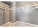 Walk-in closet with gray walls, wood-trimmed shelves, and stylish tile flooring at 6345 Strongbow Dr, Las Vegas, NV 89156