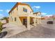 A two-story home with a covered patio and neutral paint, complemented by a concrete backyard area at 6345 Strongbow Dr, Las Vegas, NV 89156