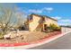 Tan two-story home with a two-car garage and a low-maintenance desert landscape at 6345 Strongbow Dr, Las Vegas, NV 89156