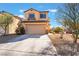 Inviting two-story home featuring a two-car garage and low maintenance desert landscaping at 6345 Strongbow Dr, Las Vegas, NV 89156