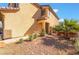 Close up of the home featuring a two-story facade, desert landscaping, and a front door at 6345 Strongbow Dr, Las Vegas, NV 89156