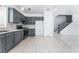 Modern kitchen showcasing grey cabinets, stainless steel appliances, stylish backsplash, and tile flooring at 6345 Strongbow Dr, Las Vegas, NV 89156