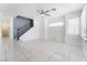 Spacious living room with tile floors, staircase, and abundant natural light from large windows at 6345 Strongbow Dr, Las Vegas, NV 89156