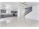 Open floor plan showcases tile floors, gray cabinets, and a staircase leading to the upper level at 6345 Strongbow Dr, Las Vegas, NV 89156