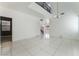 Bright, open-concept living room features a high ceiling, sleek tile flooring, and natural light at 6345 Strongbow Dr, Las Vegas, NV 89156