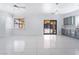 Bright living room with tile floors, recessed lighting, and sliding glass doors to the backyard at 6345 Strongbow Dr, Las Vegas, NV 89156
