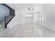 Bright and airy living room with tile flooring, staircase, and multiple windows at 6345 Strongbow Dr, Las Vegas, NV 89156