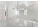 Spacious living room showcasing vaulted ceilings, tile flooring, and ample natural light from large windows at 6345 Strongbow Dr, Las Vegas, NV 89156