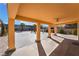 Covered patio overlooking large backyard with shade structure and desert landscaping at 6345 Strongbow Dr, Las Vegas, NV 89156