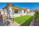 A manicured backyard featuring artificial turf and a brick border for easy maintenance at 669 Elliot Peak Ave, Las Vegas, NV 89183