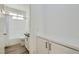 Bright bathroom with a shower over the tub, granite countertop, storage cabinets and wood look flooring at 669 Elliot Peak Ave, Las Vegas, NV 89183