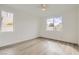 A bright, open bedroom featuring two windows and neutral color tones at 669 Elliot Peak Ave, Las Vegas, NV 89183