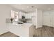 Modern kitchen with white cabinets, stainless steel appliances, and a quartz countertop island at 669 Elliot Peak Ave, Las Vegas, NV 89183