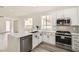 Modern kitchen featuring white cabinets, stainless steel appliances, and quartz countertops at 669 Elliot Peak Ave, Las Vegas, NV 89183