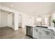 Well-lit kitchen overlooking a living area, complete with stainless steel dishwasher and quartz countertops at 669 Elliot Peak Ave, Las Vegas, NV 89183