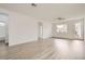 Spacious living room with wood-look floors, ceiling fan, and natural light at 669 Elliot Peak Ave, Las Vegas, NV 89183