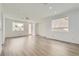 Bright living room with wood-look floors, recessed lighting, and large windows at 669 Elliot Peak Ave, Las Vegas, NV 89183