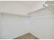 A modest walk-in closet, with two racks for hanging items and durable wood-style flooring at 669 Elliot Peak Ave, Las Vegas, NV 89183