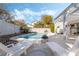 Backyard with a sparkling pool and spa, lounge chairs, fire pit, and lush landscaping at 6695 Shadow Cove Ave, Las Vegas, NV 89139