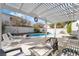 Inviting backyard oasis with a pool, spa, pergola, lounge chairs, and outdoor seating area at 6695 Shadow Cove Ave, Las Vegas, NV 89139