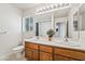 Double sink vanity with large mirror and lighting in a clean bathroom setting at 6695 Shadow Cove Ave, Las Vegas, NV 89139