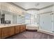 Bright bathroom with double sinks, soaking tub, glass shower, and carpet flooring at 6695 Shadow Cove Ave, Las Vegas, NV 89139