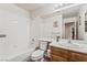 Bright bathroom featuring tub/shower combo, large mirror, and vanity at 6695 Shadow Cove Ave, Las Vegas, NV 89139