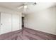 Carpeted bedroom offering a ceiling fan and a closet with sliding doors at 6695 Shadow Cove Ave, Las Vegas, NV 89139