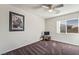 Cozy bedroom with a ceiling fan, carpeted floor, and bright window at 6695 Shadow Cove Ave, Las Vegas, NV 89139