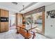Bright breakfast nook with a wooden table set and view of the backyard pool at 6695 Shadow Cove Ave, Las Vegas, NV 89139