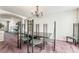 Elegant dining room featuring a modern chandelier and unique chair design at 6695 Shadow Cove Ave, Las Vegas, NV 89139