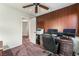 Office with wood-paneled accent wall, desk, and ample space for computer setup at 6695 Shadow Cove Ave, Las Vegas, NV 89139