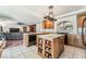 Bright and airy kitchen with a center island, granite countertops, and ample storage at 6695 Shadow Cove Ave, Las Vegas, NV 89139
