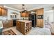 Functional kitchen featuring an island, granite countertops, and stainless steel appliances at 6695 Shadow Cove Ave, Las Vegas, NV 89139