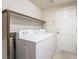 Convenient laundry room with washer, dryer, and storage shelf at 6695 Shadow Cove Ave, Las Vegas, NV 89139