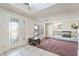 Bright living room with marble fireplace, stylish front door, and beautiful entryway table at 6695 Shadow Cove Ave, Las Vegas, NV 89139