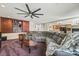 Spacious living room with a fireplace, built-in shelving, and a large sectional couch at 6695 Shadow Cove Ave, Las Vegas, NV 89139