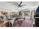 Open living room features a wet bar, fireplace, and large sectional couch at 6695 Shadow Cove Ave, Las Vegas, NV 89139