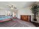 Spacious main bedroom featuring dark wood furnishings and a large decorative plant at 6695 Shadow Cove Ave, Las Vegas, NV 89139